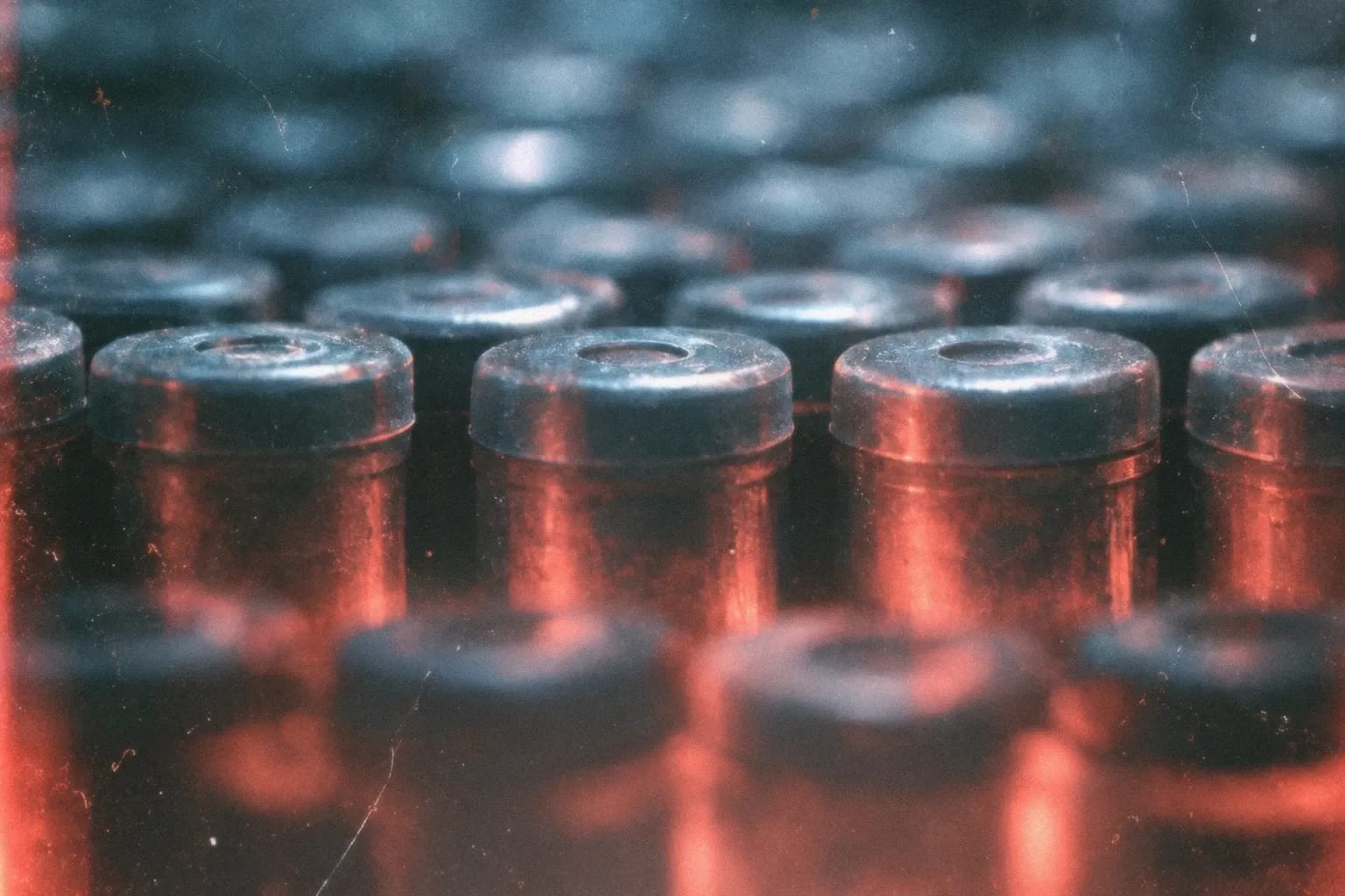 A row of rubber stoppers lit cool above and warm below